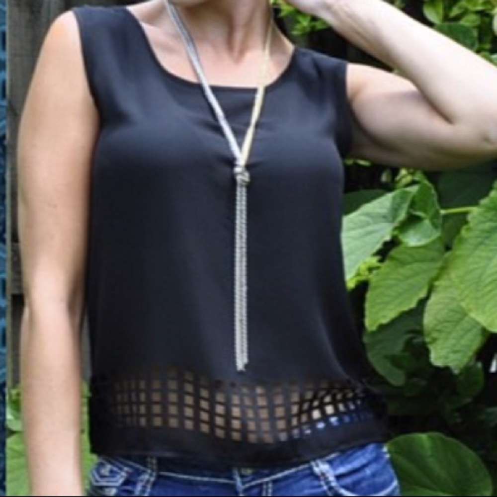 Black top with square cut outs and caged back NWOT